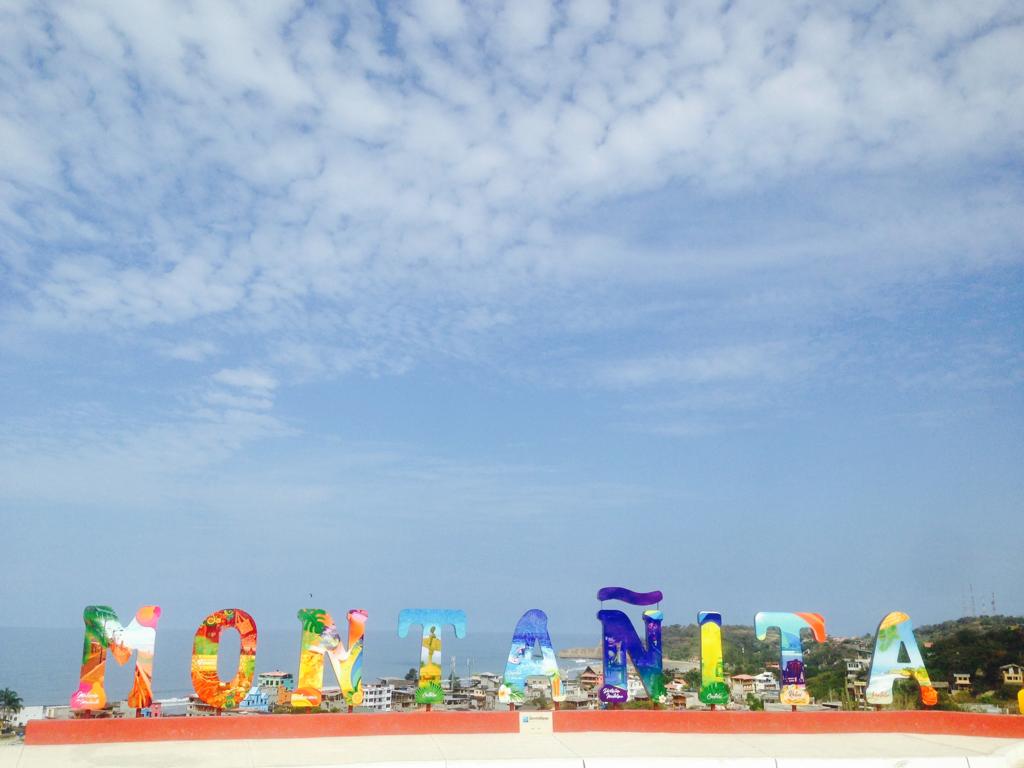 Colorful Montanita sign with scenic ocean background