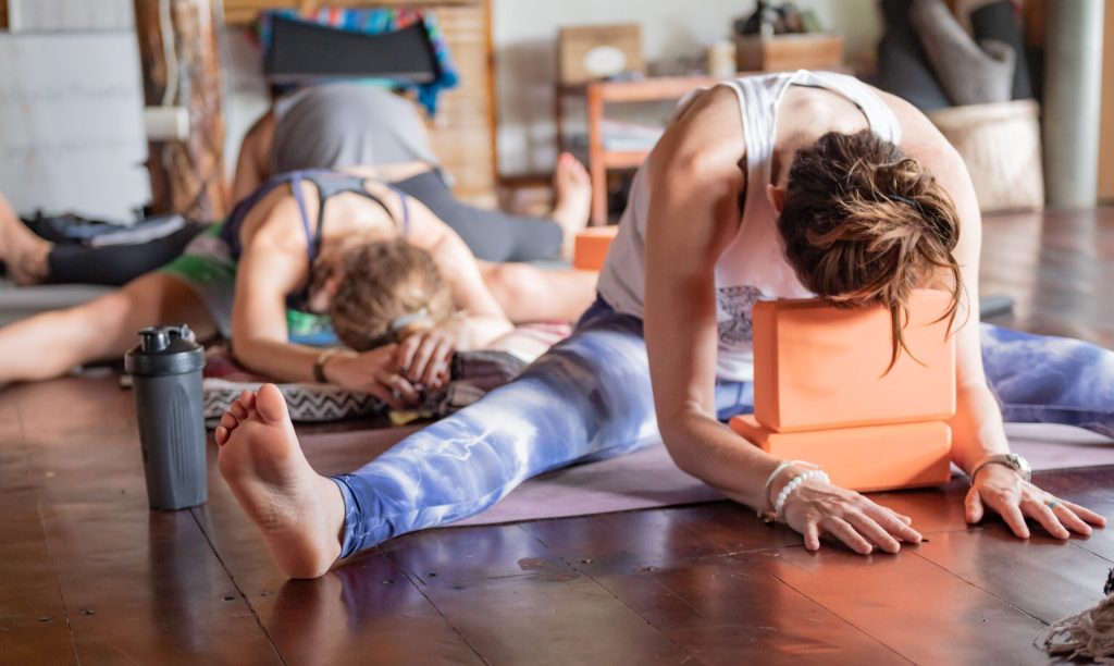 yoga3 Women practicing yoga with props in studio